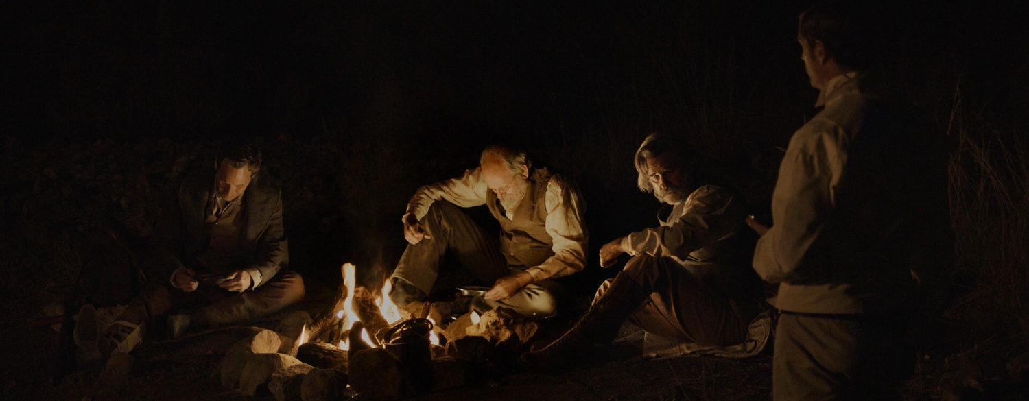 The Four Men Sit Around the Campfire