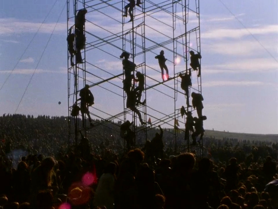 Fans Climb Scaffolding